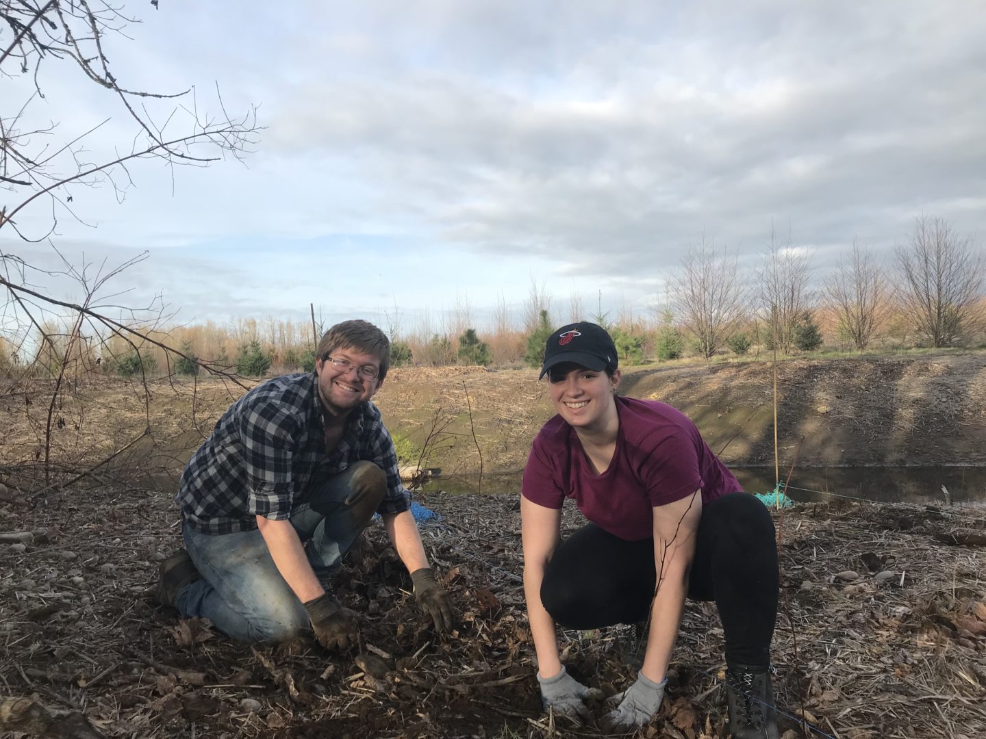 two volunteers planting trees